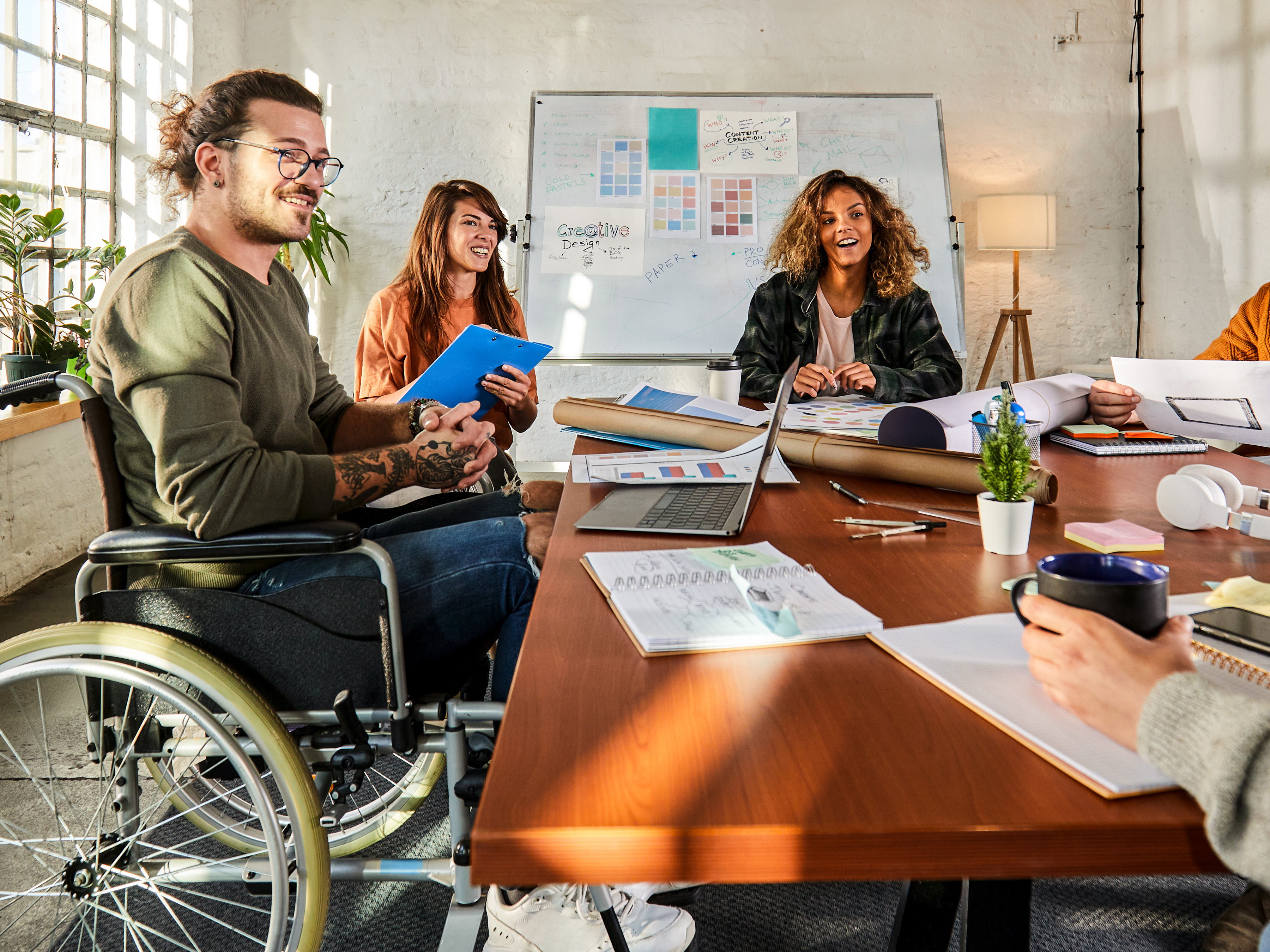 Office employees sitting together in a conference room.